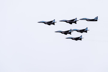 Air show in the sky above the Krasnodar airport flight school. Airshow in honor of Defender of the Fatherland. MiG-29 in the sky.