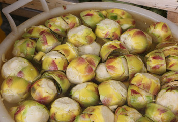 clean bottoms of artichokes prepared by the cook in the water