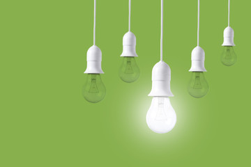 difference light bulb on green background. concept of new ideas with innovation and creativity.