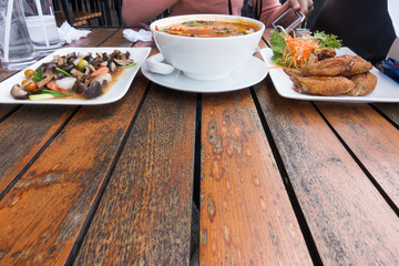 Thailand : Tom yum, chicken wing fried and fried mushroom on wooden table  with copy space