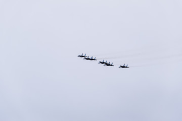 Air show in the sky above the Krasnodar airport flight school. Airshow in honor of Defender of the Fatherland. MiG-29 in the sky.