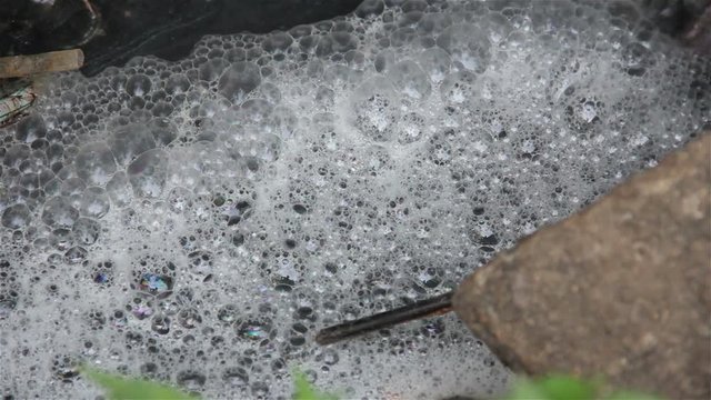 Bubbles of dirty water from the drainage pipe.