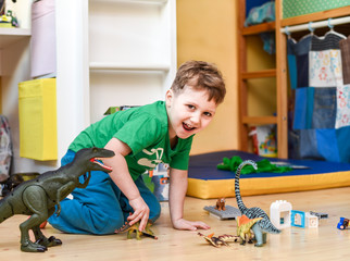 Boy play with dinosaurs