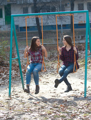 Two teenage girl on the swing