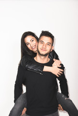 man woman, brother sister carrying on back smiling happy