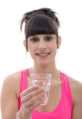 young woman drinks a glass of water, on white