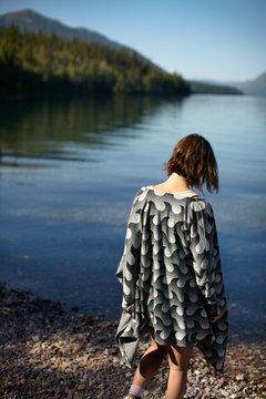 Rear view of a woman walking towards lake