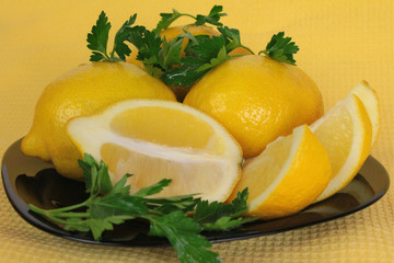 Fototapeta na wymiar slash-lemons on a black plate