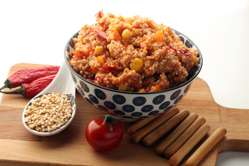 Delicious vegetarian quinoa salad with bell pepper, cucumber and tomatoes