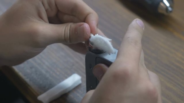 Close-up - man put the wadding into spring in vape