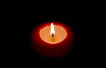 Red candle isolated on a black