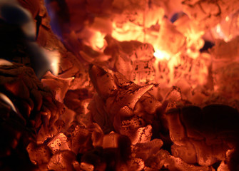 The glowing embers burn out in the wood stove