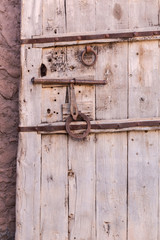 Old vintage massive wooden door with metal locker and handle