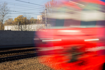 Red train in motion blur, illustrates the speed, movement, transience, tourism, travel. Photographed in Russia, a regular commuter train, public transport.