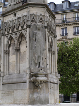 Part of fountain de la Vierge near Notre-Dame with statue of  angel Paris, France