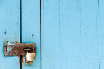 Old wooden door with rusty padlock and lock for background use