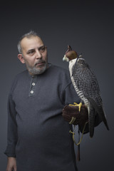 The man with the peregrine falcon in the studio