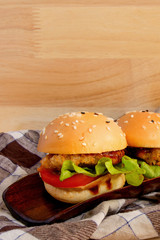 Delicious hamburger on wooden background