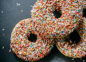 donuts on black background. top view