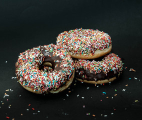 tree donuts on black background