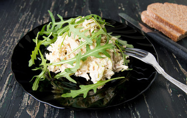 Chicken salad with rucola on a plate