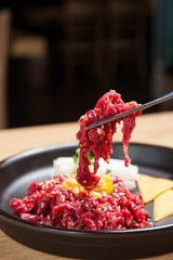 raw beef with chopsticks