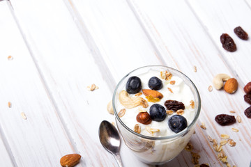 Healthy dessert with yogurt, nuts, oats and blueberries