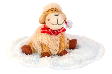 Smiling sheep sitting on white soft cloth as snow isolated over white , Christmas decoration object