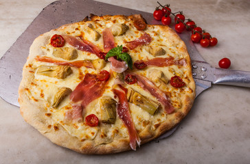 Hot pizza on a paddle, straight from the oven.