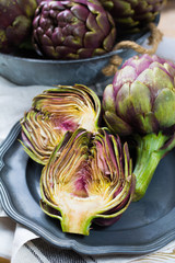 Obraz premium Fresh big Romanesco artichokes green-purple flower heads ready to cook