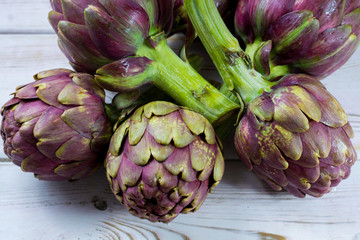 Fototapeta premium Fresh big Romanesco artichokes green-purple flower heads ready to cook