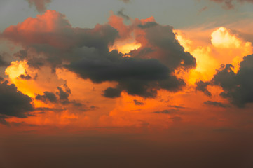 Clouds at sunset in the rays of the setting sun paints play