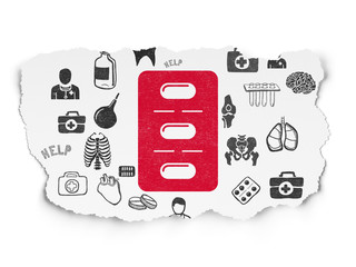 Health concept: Pills Blister on Torn Paper background