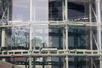 The steel frame of the glass of a skyscraper downtown.