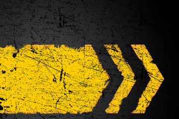Grunge distressed yellow direction road marking on dark metal background
