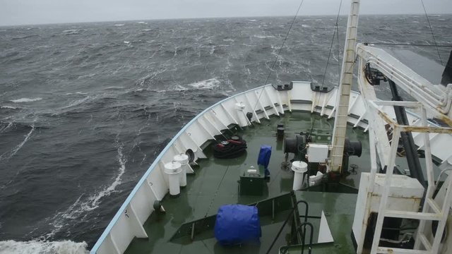 Big wave rolling over the snout of the ship