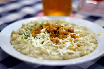 gnocchi with bacon white plate on table in restaurant