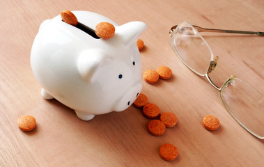 Piggy bank and pills. Medicines cost concept.