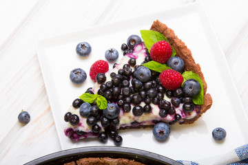 Delicious tart with blueberries and raspberries