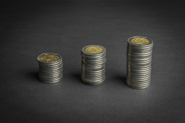 Stack of coins on dark background (Polish Five Zloty coins) - business concept