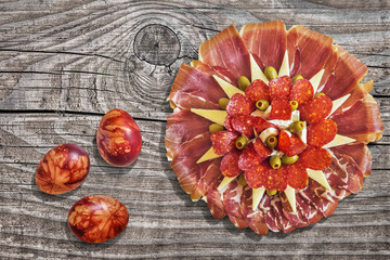 Serbian Traditional Appetizer Savory Dish Meze with Colorful Easter Eggs Set on Old Weathered Cracked Knotted Pine Wood Table Surface