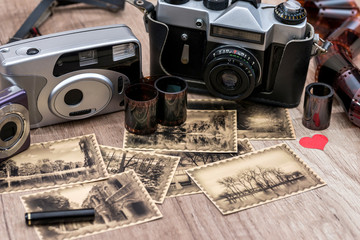 Old camera and photos with retro image. close up