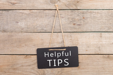 Blackboards with inscription "Helpful TIPS" on wooden background