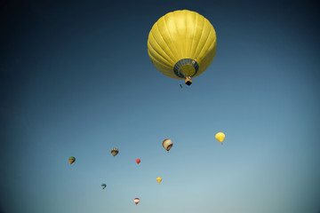 Start of big hot air balloons at the field with cool cloudy sky
