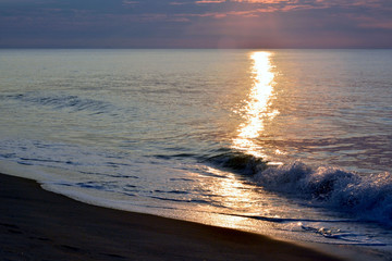 Fototapeta premium Golden and Glistening Sunrise Seas at the Shore