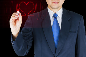 Businessman is writing red heart line over black background. Photo is focused at hand.
