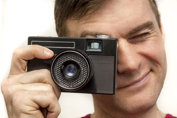 Man in a red shirt with old camera, photo shooting, white background