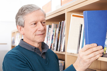 Fototapeta premium Mature Male Student Studying In Library