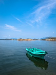 Naklejka premium Beautiful Lake Landscape with an isolated boat in Senanayake Samudraya Galoya National Park Inginiyagala, Ampara, Sri Lanka