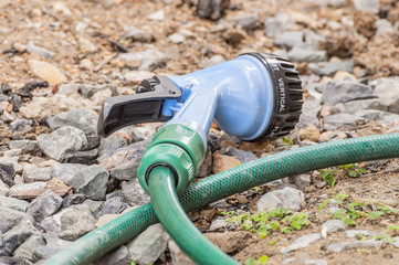 Garden hose nozzles and sprayer on ground